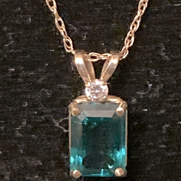 10 karat Simulated Emerald and diamond pendant with chain
